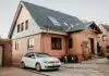 white Volkswagen Jetta parked beside house