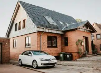 white Volkswagen Jetta parked beside house